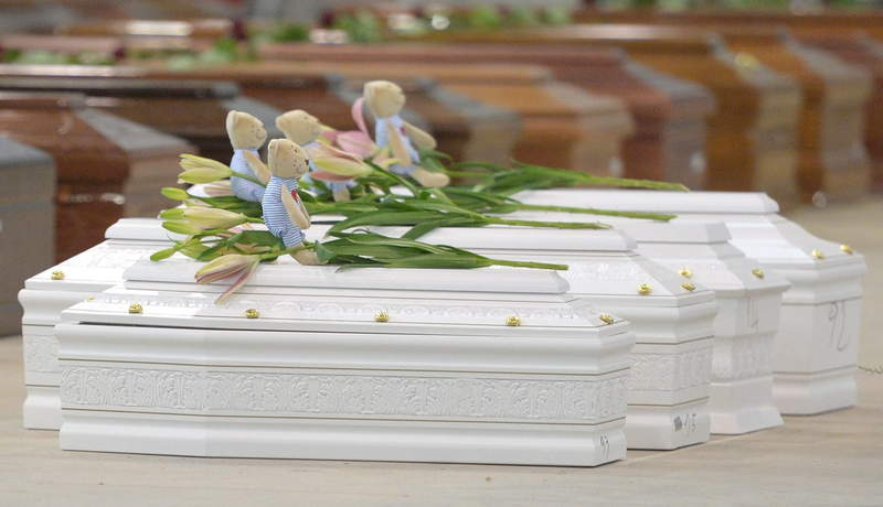 Coffin of victims are seen in an hangar of Lampedusa airport